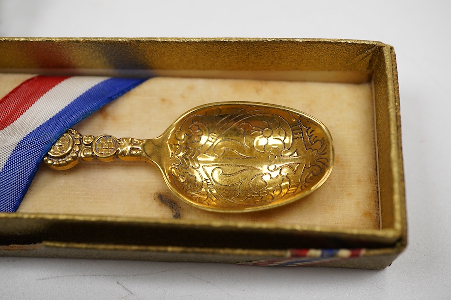 A cased set of six George V silver teaspoons and pair of sugar tongs, by Walker & Hall, Sheffield, 1918, together with a set of ten sterling coffee spoons, with floral terminals, a sterling tea strainer and a boxed Eliza